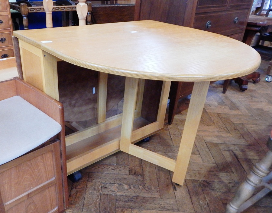 An ash gateleg table on castors,