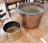 A large copper log cauldron, 64cm and brass two-handled pot,