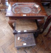 A mahogany rectangular top side table holding a beaten copper tray,