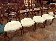 Set of four Victorian walnut hoop back dining chairs with foliate scroll top rail,