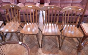 A set of four lath back kitchen chairs,