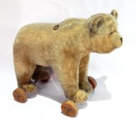 Early to mid 20th century Steiff bear on wheels, golden plush body, ring pull growling mechanism, on