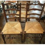 Harlequin set of seven oak ladderback dining chairs with rush seats,