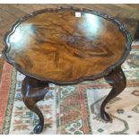 Reproduction walnut veneer circular top coffee table with moulded piecrust border on cabriole legs
