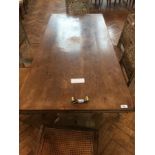 A Victorian rectangular top limed oak dining table on trestle supports united by central stretcher