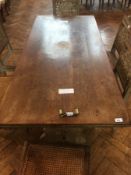 A Victorian rectangular top limed oak dining table on trestle supports united by central stretcher