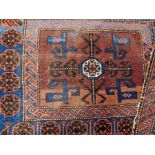 A small Eastern wool saddle rug on a blue and red ground with geometric pattern, gul border,