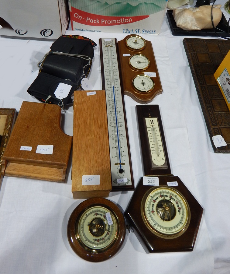 An aneroid barometer, another barometer,