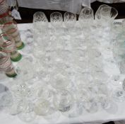 A large collection of cut glass including tumblers, brandy balloons, wines,