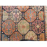 A Persian style wool rug with blue field with shaped guls and geometric pattern,
