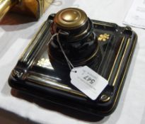 An inkwell decorated in gold and green banding together with a brass GNER railway lamp