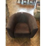 A modern leather tub armchair with loose cushion seat on turned tapering legs