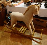 A rocking horse with fur covered horse,