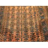 An Eastern wool rug with red field and geometric pattern,