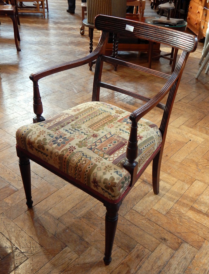 Matched set of Regency mahogany dining chairs with bar backs, upholstered stuff-over seats,