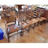 A set of six oak Carolean style dining chairs with carved crest rails,