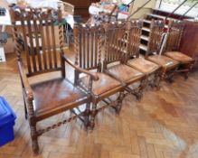 A set of six oak Carolean style dining chairs with carved crest rails,