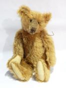A modern collector's bear, golden plush jointed body, matt eyes, stitched nose, fabric pads,