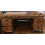 A Georgian style walnut pedestal desk with inset leather writing surface,