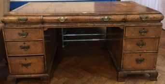 A Georgian style walnut pedestal desk with inset leather writing surface,