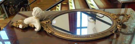 Rococo style gilt wall mirror, oval with floral pediment,