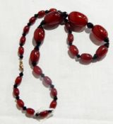 Amber coloured bead and jet necklace with red graduated beads and 9ct clasp