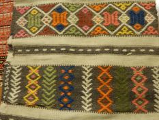 Wool rug of geometric design in bright colours, probably South American,