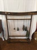 Oriental stand of Temple style brass bells, on oak stand, with curved top,