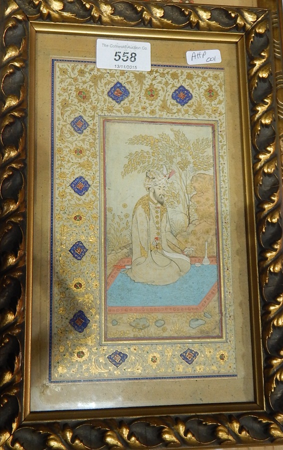 Indian/Persian painting of man in traditional dress at prayer with ornate gilt border,