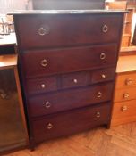 A Stag chest of four long and three short drawers, brass ring handles, loose plate glass top,