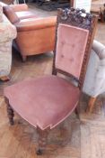 A late Victorian carved walnut framed nursing chair, with upholstered buttoned panel back,