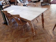 An old pine rectangular top dining table, with two end frieze drawers, on ring turned legs,