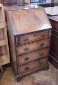 A reproduction mahogany bureau of small proportions, with fitted interior,