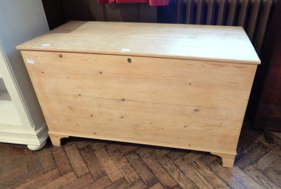 A modern pine blanket box raised on bracket feet,