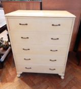 A modern white painted hardwood chest of five long drawers, raised on short cabriole legs,