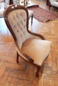 A Victorian style button back chair with beige upholstered seat on cabriole legs