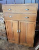 A mid 20th century pale oak dressing chest of two long drawers, with stylised handles,