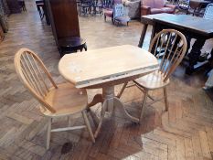 A modern circular top drop leaf table, on turned pedestal support with splayed legs, diameter 91cm,