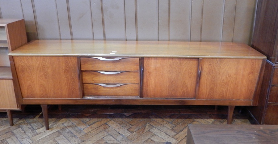 A circa 1960's hardwood sideboard with three central short drawers,