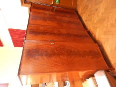 A pair of reproduction mahogany wardrobes, the pair panel doors enclosing hanging space and shelves,