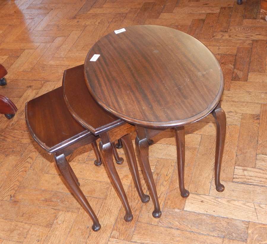 A nest of three oval top occasional tables, on turned legs and pad feet,
