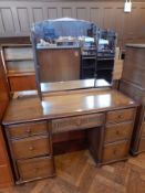 A modern elm kneehole dressing table, with triple mirror back, frieze drawer,