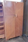 A Fitrobe gentleman's wardrobe with panel doors opening to reveal hanging space,