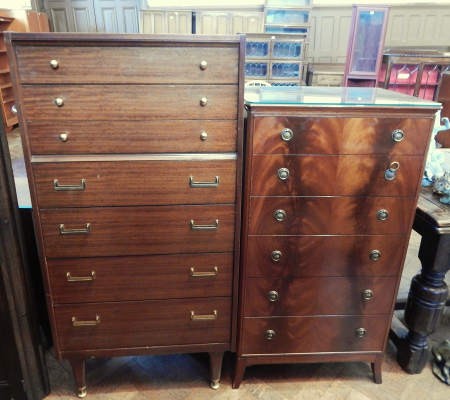 A G-Plan chest of seven drawers, with brass handles, raised on turned tapering legs,