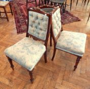 A set of three late Victorian walnut framed single chairs, with button panelled backs,