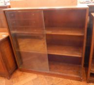 Three modern oak bookcases with glazed sliding doors,