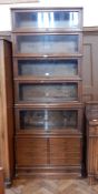 A Globe Wernicke oak sectional glazed bookcase with five glazed shelves above eight short drawers,