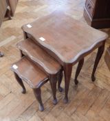 A nest of three occasional tables, with serpentine shaped moulding,