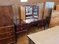 A Stag dressing table with loose breakfast top, central frieze drawer, flanked by two short drawers,