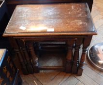 A nest of three oak occasional tables, on turned baluster legs,